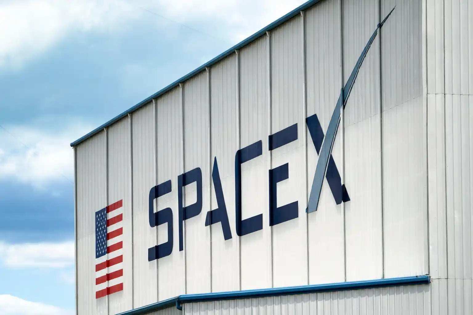 SpaceX logo displayed on the exterior of a company building