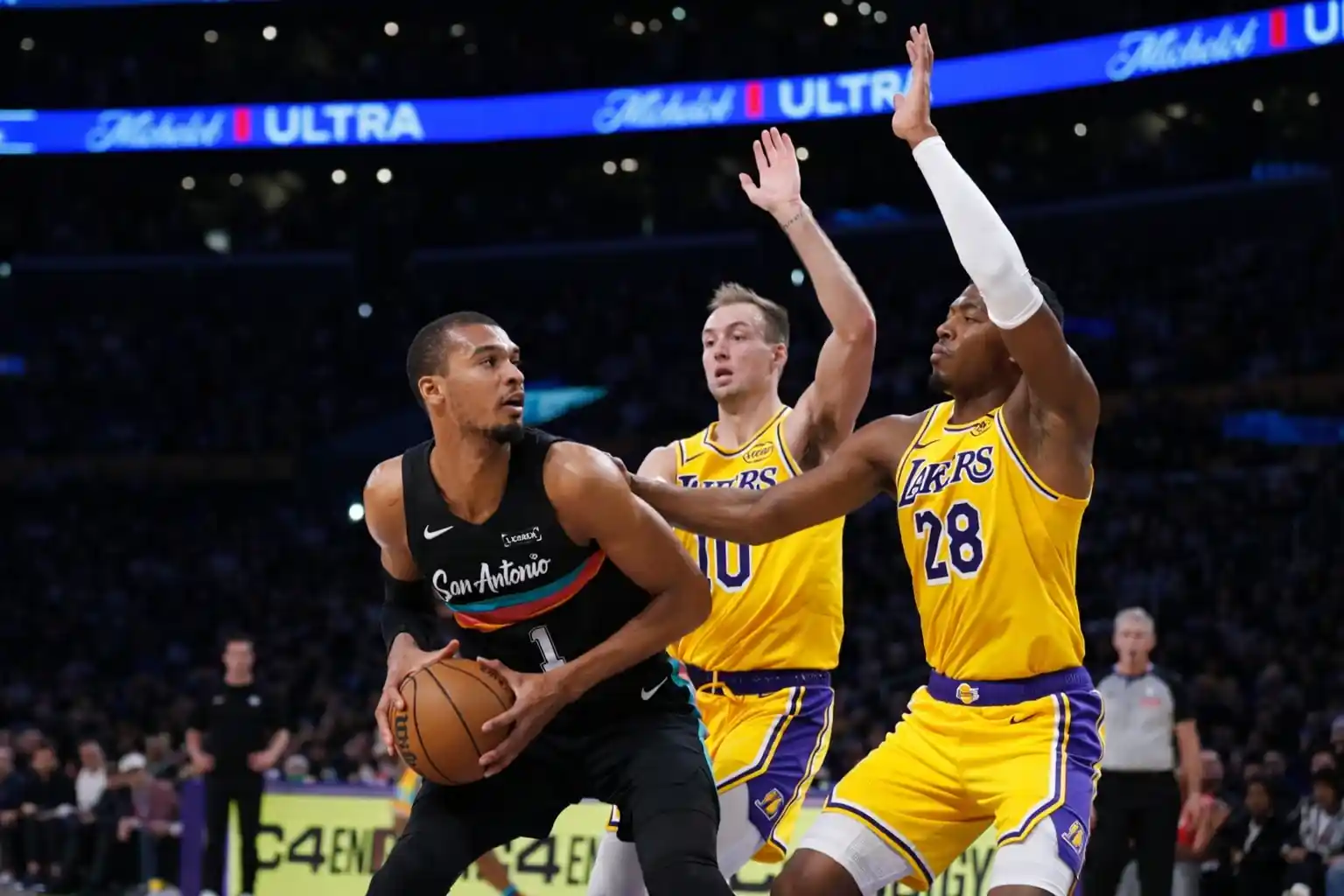 Victor Wembanyama in action, dribbling the ball during a game between the San Antonio Spurs and Los Angeles Lakers
